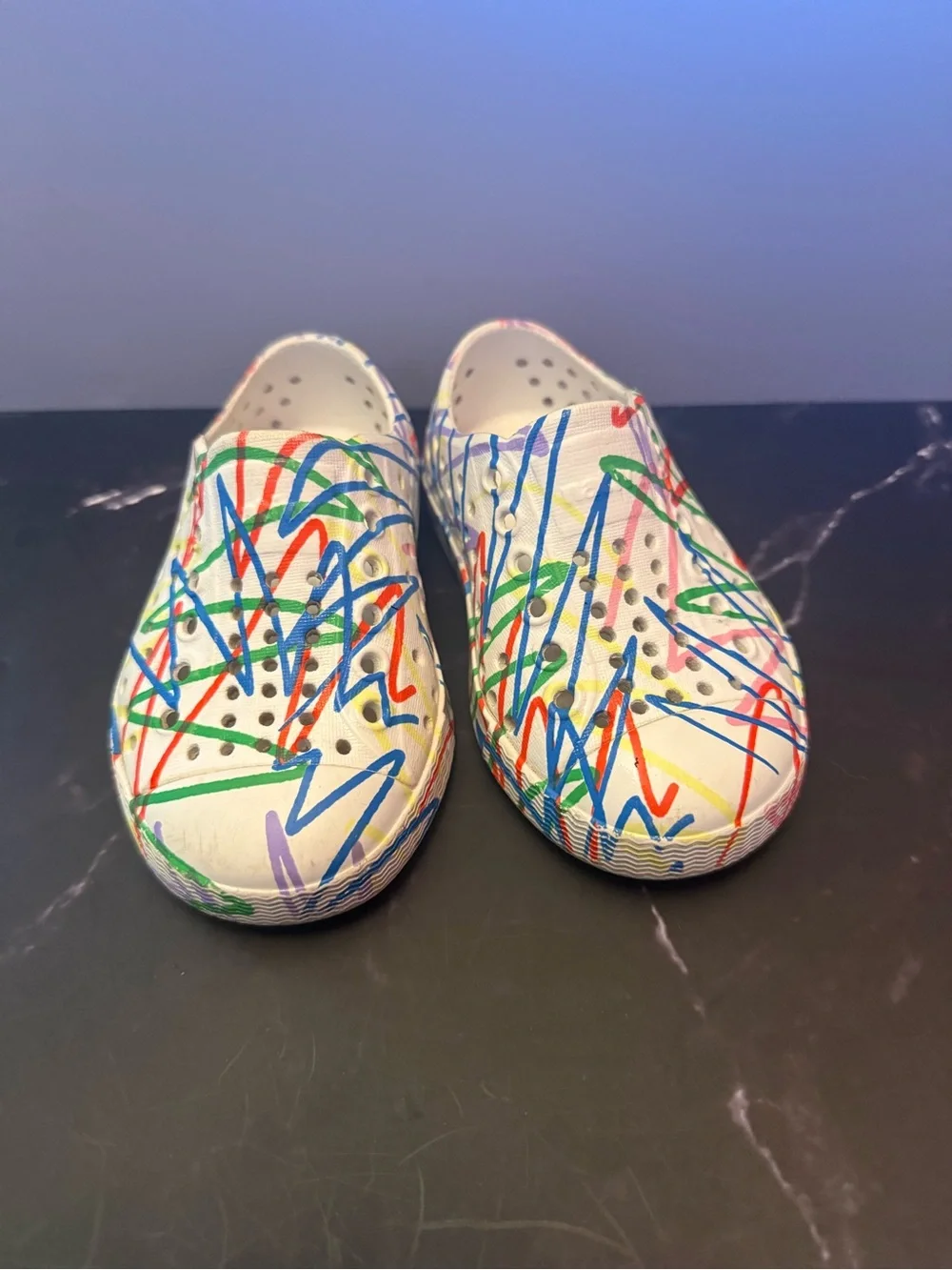 Native Kids White Slip-On Shoes with Crayola Multicolor Scribble Print
